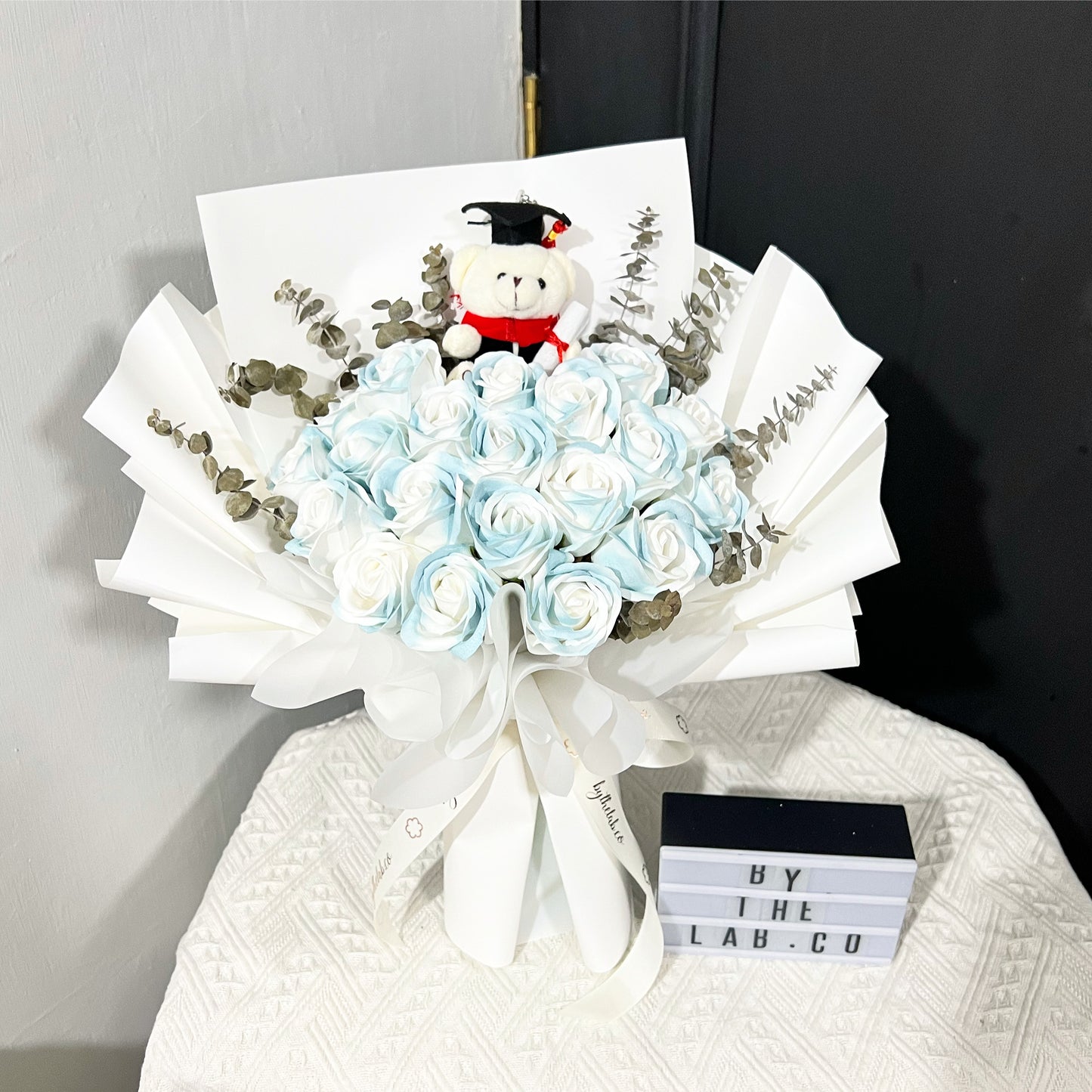 Graduation Bear with Soap Roses Bouquet in White Wrapper - Aurora Blue Roses